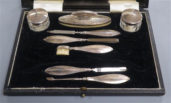 A cased 1930s eight piece (ex ten) silver mounted manicure set.